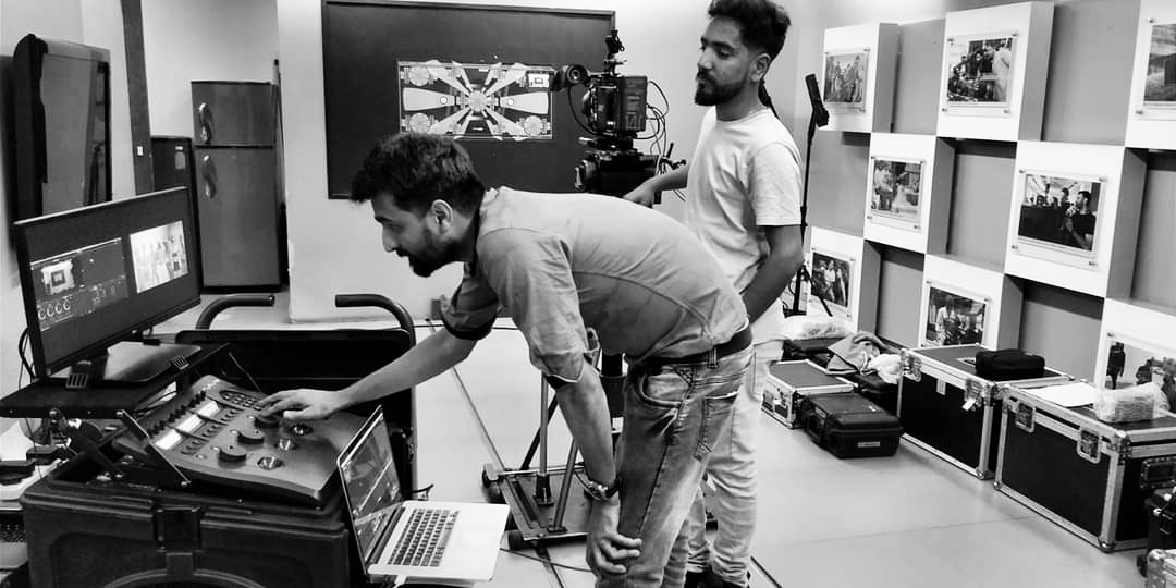 Professional DIT setup: Technical workstation with multiple monitors and color grading equipment