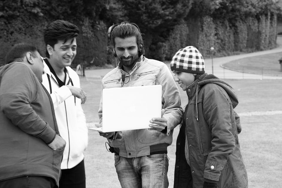 Behind-the-scenes: Crew collaboration on outdoor film set with lighting equipment